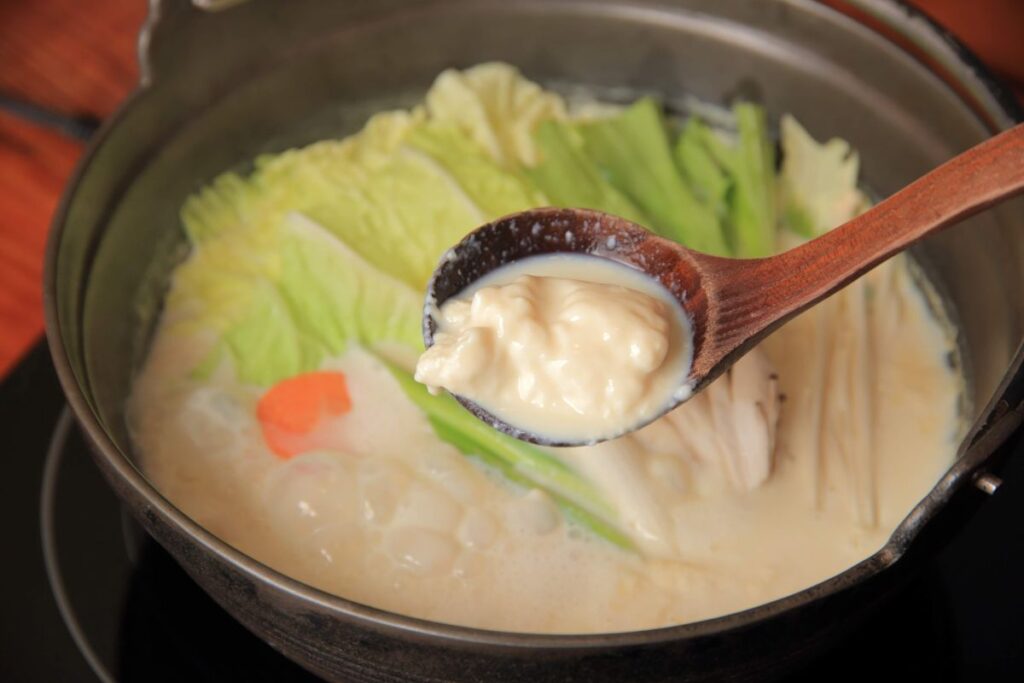 白濁したスープにセットの野菜やキノコ類を入れて豆乳鍋に。